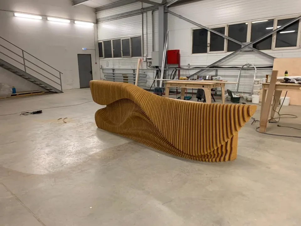 G Reception Desk, diagonal workshop perspective showing the deep curved end panel.
