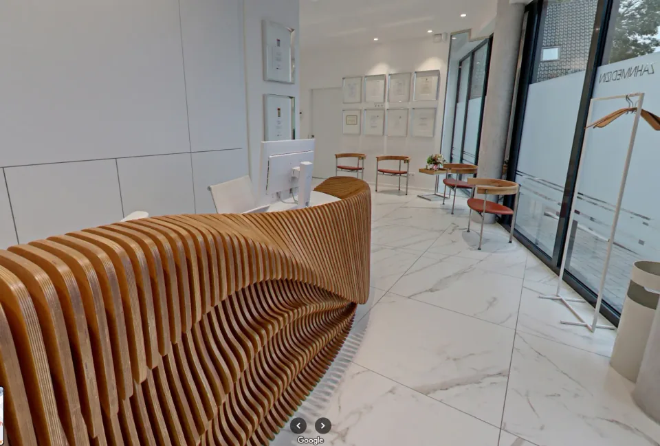G Reception Desk, side perspective of the desk installed beside a glazed wall.